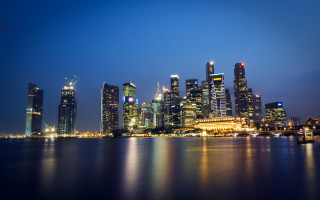 City skyline night water boat 10 - a boat in the foreground free wallpaper