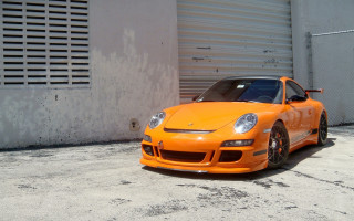Bright orange sports car garage 3 - plasticien free wallpaper