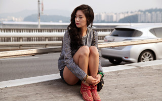 Woman sitting gray sweater red - a ledge next free wallpaper