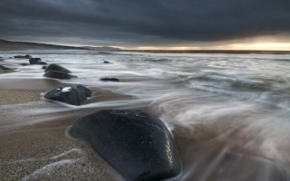 Stormy beach rocks water night - rock and water free wallpaper