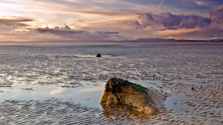 Rock water person distant landscape - alan sutherland free wallpaper