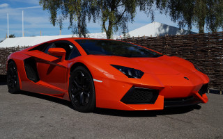 Bright orange sports car parking 12 - a parking lot next free wallpaper
