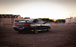 Black car sunset fence backlit - a black car free wallpaper