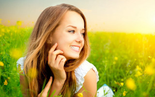 Woman smiling flower field outdoors - facial muscle free wallpaper