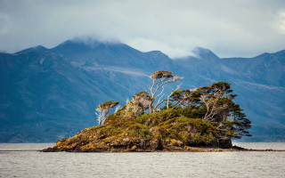 Small island trees lake mountains - the middle of a lake free wallpaper