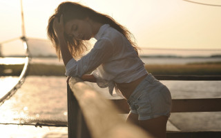 Woman beach driftwood sunset denim - a photorealistic painting free wallpaper for desktop