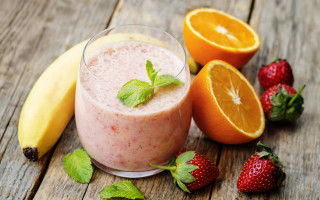 Smoothie strawberries oranges wooden table - a wooden table free wallpaper