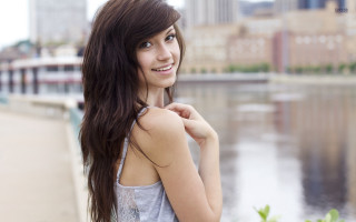 Woman water city bridge background - a city in the background and a bridge in the foreground free wallpaper