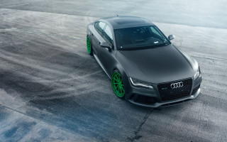 Black car green rims concrete - a concrete surface free wallpaper