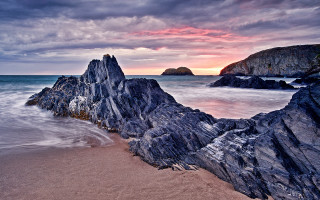 Rocky beach sunset water formation - a rock formation in the foreground free wallpaper