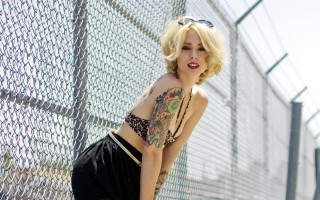 Fence tattoo blonde city fishnets - a woman leaning against a fence free wallpaper