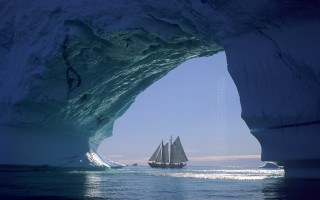 Sailboat iceberg ocean mountains sky - a large iceberg free wallpaper