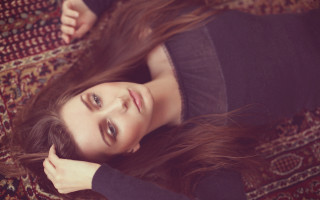 Woman laying rug blurry portrait - a rug free wallpaper