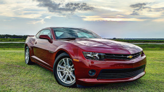 Red chevrolet camaro field cloudy - a cloudy sky in the background free wallpaper