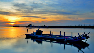 Sunset boat water mountain sky - a boat in the background and a boat free wallpaper