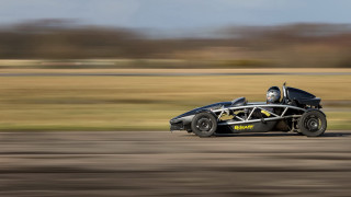 Black racecar driving road grass - a road next free wallpaper