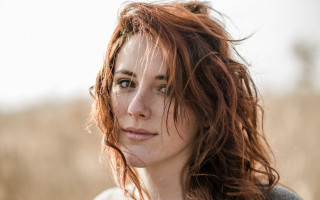 Red haired woman field serious - tall grass free wallpaper