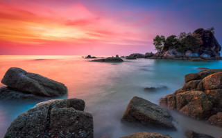 Colorful sunset rocky beach island - a small island in the distance free wallpaper