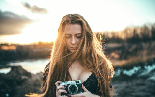 Woman holding camera beach lake - long hair holding free wallpaper