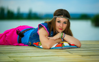 Woman laying water colorful dress - a wooden floor next free wallpaper