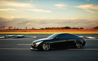Black sports car blue cloudy - a parking lot free wallpaper