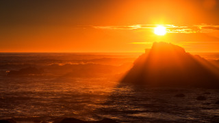 Sunset ocean rocks dusk lighthouse - a rock formation in the foreground free wallpaper