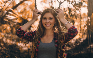 Woman longhair plaidshirt smiling woods - holding free wallpaper