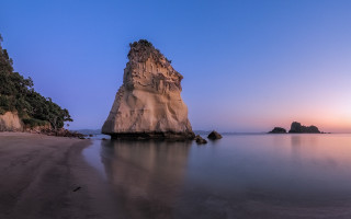 Rock outcrop water beach sunset - widescreen free wallpaper