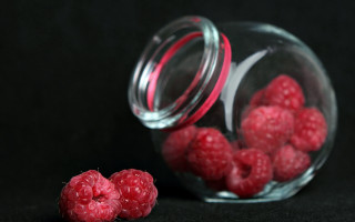 Raspberry jar stilllife black background - a glass jar free wallpaper