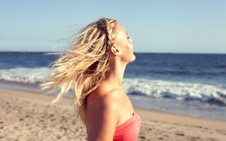 Woman red top beach sky - flowing hair free wallpaper