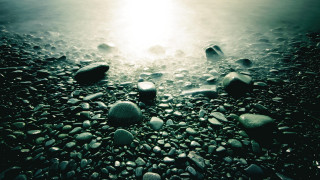 Beach rocks water sunlight person - a group of rocks free wallpaper