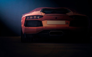Red sports car dark spotlight - a red sports car free wallpaper