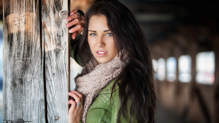 Woman holding door serious look - a wooden door free wallpaper