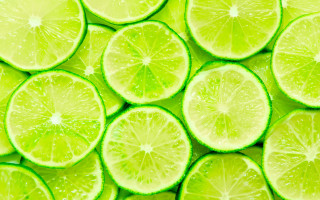 Limes halved stacked water droplets - a close up of a bunch free wallpaper