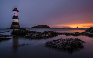 Lighthouse rocky shore sunset purple - a rocky shore free wallpaper