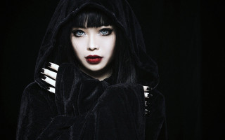 Gothic woman blueeyes blackhood blackbackground - a black curtain free wallpaper