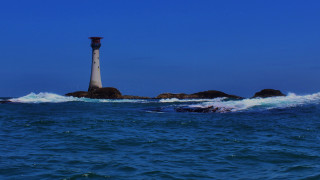 Lighthouse rocky island ocean waves - a photo free wallpaper