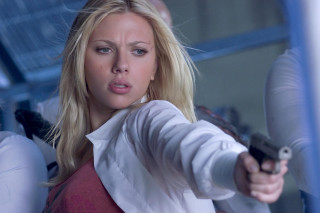 Woman gun pointing camera serious - her right hand free wallpaper