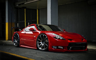 Red sports car yellow stripe 2 - a parking garage next free wallpaper
