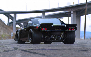 Black car big tire bridge - ed roth free wallpaper