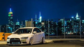 White car city skyline night 5 - a city skyline in the background free wallpaper