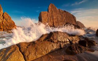 Large rock wave shore beach - a large rock free wallpaper