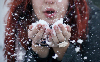 Woman snow blowing starry night - front of her face free wallpaper