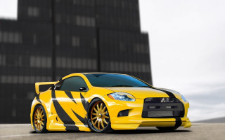 Yellow sports car black stripe - side and a building in the background free wallpaper