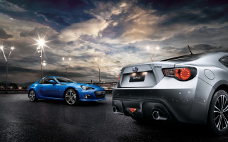 Blue sports car parking lot 12 - a parking lot under a cloudy sky free wallpaper