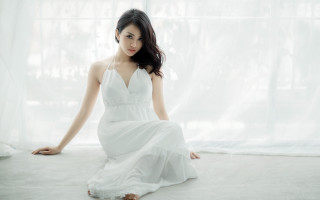 Woman white dress sitting window 2 - a white curtain behind her free wallpaper