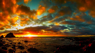 Sunset rocky beach rock formation 3 - a large body of water free wallpaper