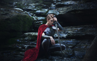 Woman red cape forest sitting - a rock in a forest free wallpaper