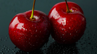 Red apples water droplets black - a black surface free wallpaper