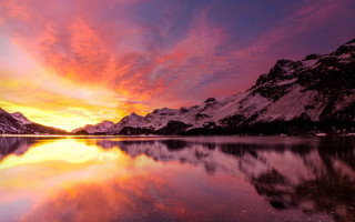 Mountain reflection sunset colorful sky - a mountain range in the distance free wallpaper